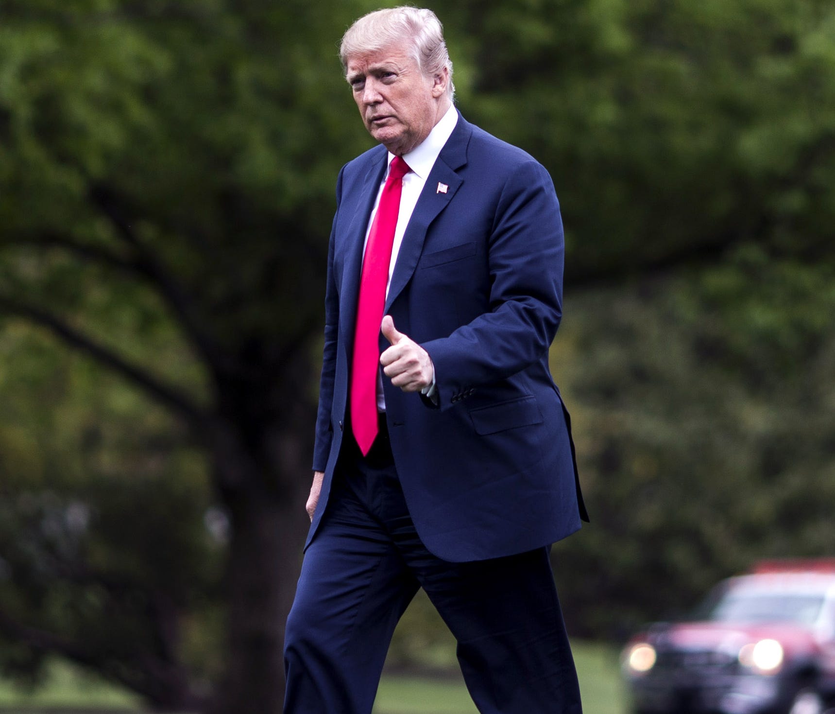 President Trump crosses the South Lawn after arriving at the White House.