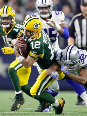 Green Bay Packers' Aaron Rodgers rushes for a fourth