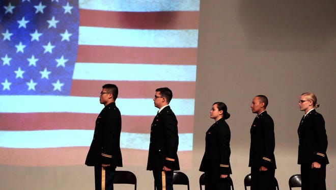 Islanders being commissioned into the Army stand at attention during the National Anthem during the Texas A&M University-Corpus Christi Islander Army ROTC Commissioning Ceremony on Friday, Aug. 4, 2017. The ceremony marks the transition of graduating ROTC students from cadets to enlisted officers. Each will be commissioned a second lieutenant in the Army.