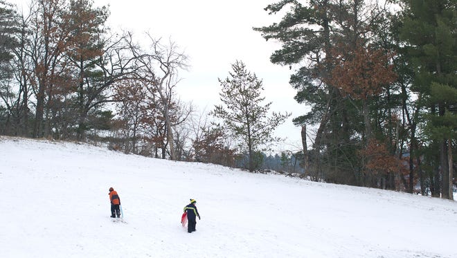 Children take to the sledding hill at Nepco Lake County Park in Wisconsin Rapids.