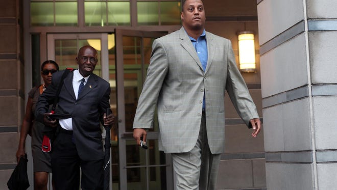 FILE - In this Sept. 23, 2011, file photo, former NBA player and University of Connecticut star Tate George leaves federal court in Newark, N.J. Tate George is in federal court in New Jersey for a sentencing hearing on fraud charges connected to an alleged Ponzi scheme. Wednesday's, Jan. 20, 2016, hearing in Trenton is a continuation of hearings that began in December.  (Leslie Barbaro/The Record of Bergen County via AP,  File) ONLINE OUT; MAGS OUT; TV OUT; INTERNET OUT;  NO ARCHIVING; MANDATORY CREDIT