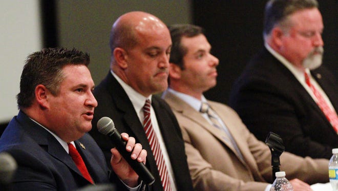 Candidates for Lafayette Parish Sheriff (from left) John P. Rogers, Chad Leger, Mark Garber and Rick Chargois participate in a Lafayette Parish sheriff candidates forum hosted by the Upper Lafayette Economic Development Foundation on May 21.