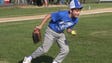 The Blue team pitcher fields a grounder and prepares