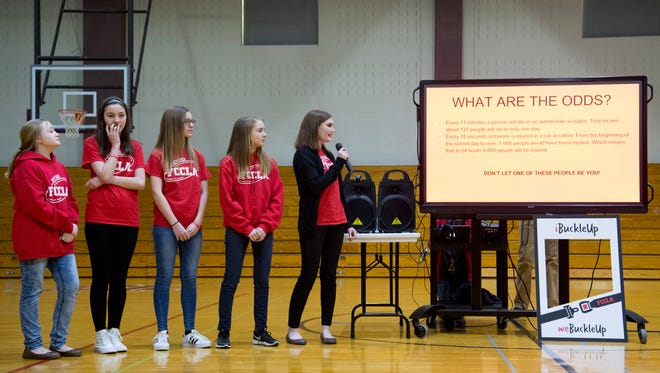 Lacie Page, 14, takes the microphone during an assembly at Mount Vernon Junior High School highlighting the need for wearing seat belts, iBuckleUP weBuckleUP, Friday afternoon. The other members of Family, Career and Community Leaders of America (FCCLA) are, from left, Emma Davis, 12, Olivia Culley, 13, Abbie Dickinson, 14, and Destiny Morgan, 14.