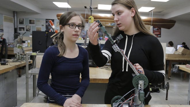 Kaylyn Brandl and Taryn Leverance work on their robot which they will use in the Skills USA competition.  Skills USA is a club that does STEM type of projects and they present them in competitions.  The Merrill Middle school students are looking for a uniform so that they can present their projects but the uniforms are expensive and are trying to find funding for the Blazers they need to be competitive.