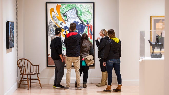 Viewers examine Ahab's Leg by Frank Stella, part of the Sargent to Basquiat exhibit of works from the collections of University of Vermont alumni at the Fleming Museum in Burlington on Thursday, October 27, 2016.