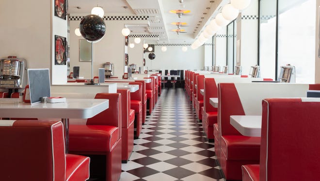american diner restaurant style in black and white tiles and red booths