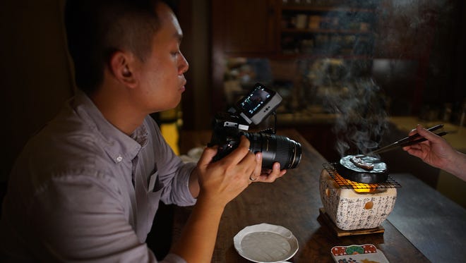 Andrew Gooi of Food Talkies (pictured), films a scene from "Kakehashi: A Portrait of Chef Nobuo Fukuda," a documentary about the acclaimed James Beard award-winning chef behind Nobuo at Teeter House in Phoenix.