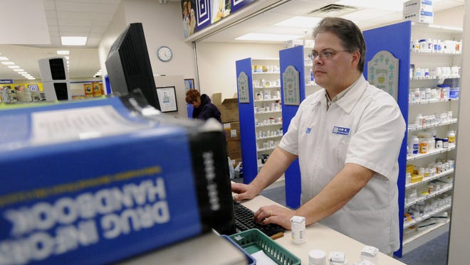 Jim Rasmussen, chief pharmacist at Lewis Drug at 10th and Cliff works on a computer Thursday afternoon.

(Elisha Page/Argus Leader)