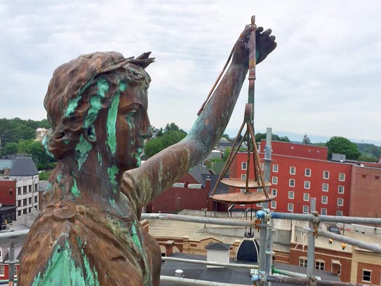 The statue of Lady Justice with her scales on top of