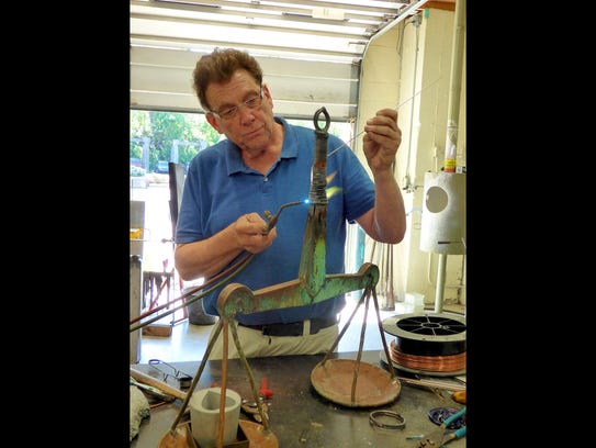 Doug Sheridan of Sunspots Studio works on the scales