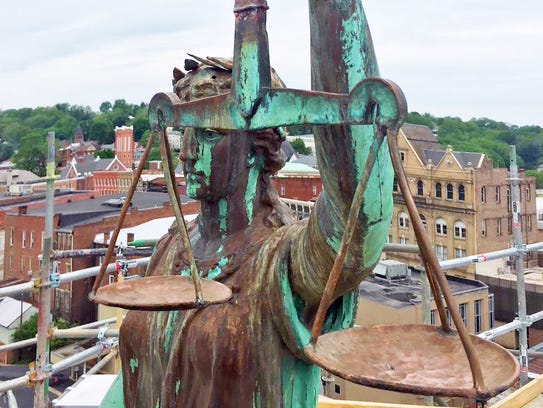 The statue of Lady Justice with her scales on top of