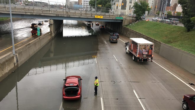 Motorists struggle through a flooded I-75 at Grand River on Tuesday, Aug. 16, 2016 in downtown Detroit.