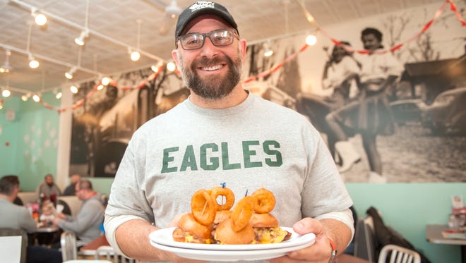 Stink Fisher, owner of the Pop Shop in Collingswood, displays cheesesteak sliders with whiz.  