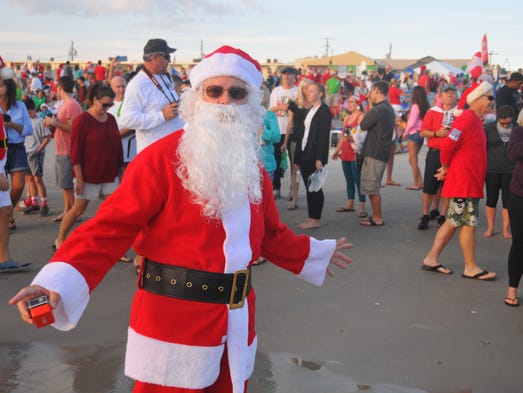 Thousands turned out to watch hundreds of surfing Santas