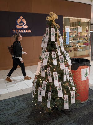 A Salvation Army giving tree stands in Laurel Park Mall. Does your favorite mall have extended hours for Thanksgiving and Black Friday?