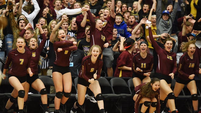 Harrisburg teammates and the student section roar with excitement after defeating Roosevelt to win the S.D. State AA Volleyball championship at the Swiftel Center in Brookings.