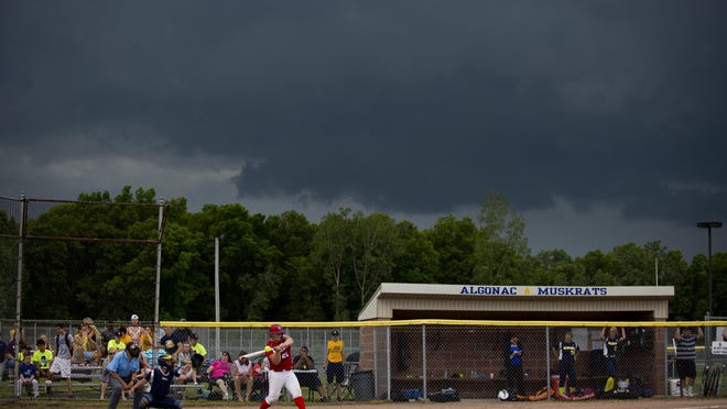 St. Clair's Taylor Westrick is up to bat as a storm approaches during a division 2 softball final Saturday, May 30, 2015 at Algonac High School.