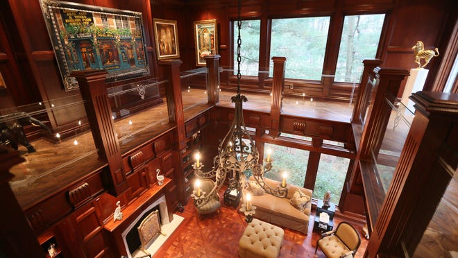 Above: Detroit school supply vendor Norman Shy had this two-story mahogany library in his custom home in Farmington Hills. The Free Press featured the estate in a House Envy article in 2013. Below: The home, which sold for $2.4 million in 2014, also had an indoor lap pool with a Jacuzzi.