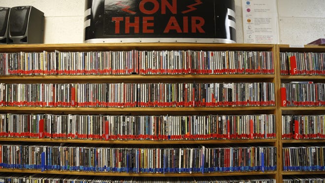 CDs line the walls of the music library behind the studio of KOOP 91.7 FM radio. This year, the nonprofit station celebrated 25 years on Austin's airwaves.