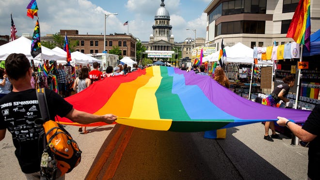 A rainbow flag, carried by staff and volunteers from the Phoenix Center during the Springfield PrideFest parade, makes its way down Capitol Avenue on May 19, 2018, in Springfield.