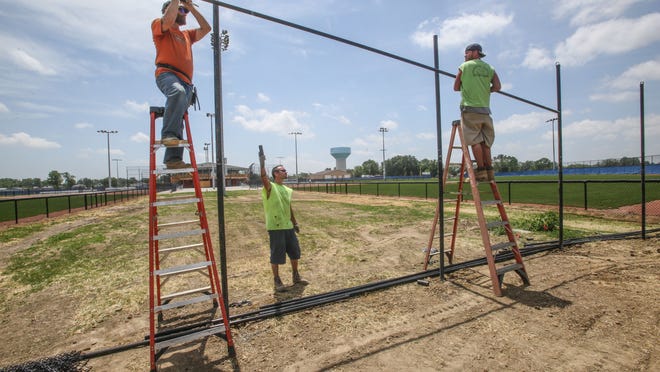 Monday June 16th, 2014,, Imperial Fence workers, Bill Valentino (left), Andrew Traylor (center), Anthony Traylor (right), put finishing touches on fencing at the  Hendricks County Sports Complex,  10508 E.U.S.136, Clermont, IN.