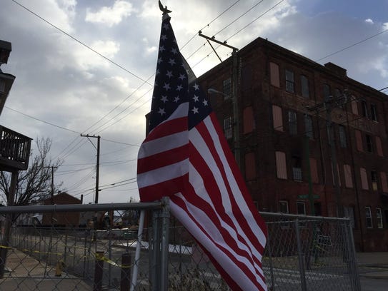 An American flag is placed at the Weaver building,