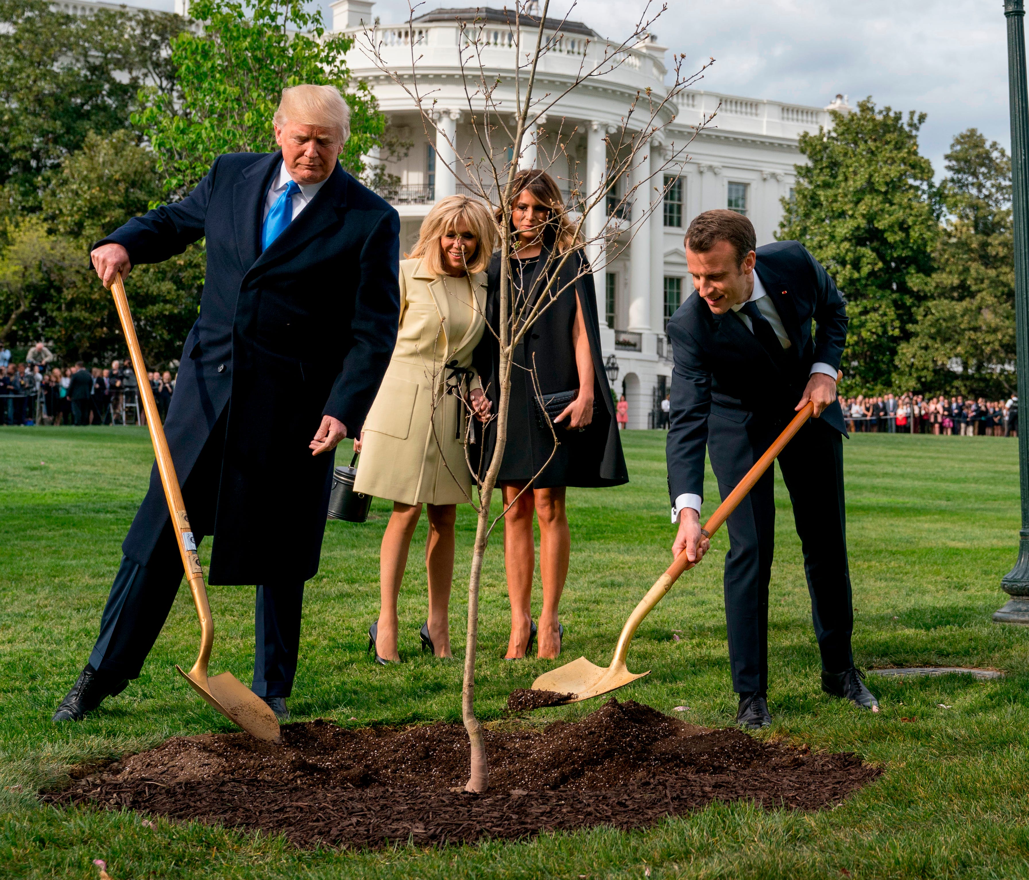 First lady Melania Trump and Brigitte Macron watch April 23 as President Trump and French President Emmanuel Macron participate in a tree planting ceremony on the South Lawn of the White House.
