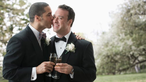 Newlywed grooms kissing