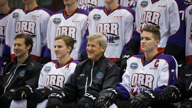 Team Orr coach Bobby Orr, bottom second from right, sits between Jake Bean, second from left, of the WHL's Calgary Hitmen, and Matthew Tkachuk, of the OHL's London Knights, during a photo before the CHL/NHL Top Prospects Game in Vancouver, British Columbia, Thursday, Jan. 28, 2016.