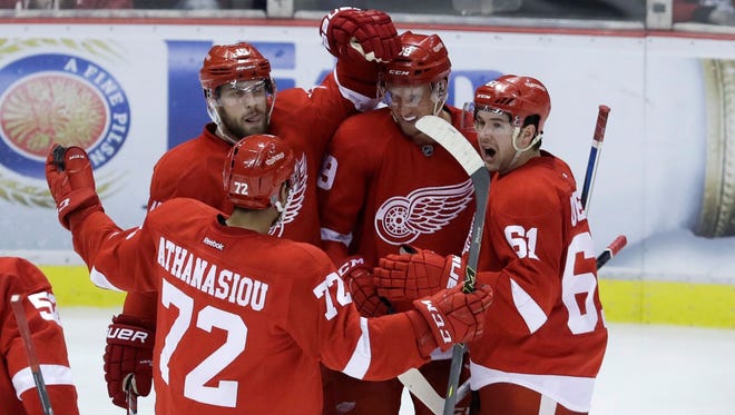 Detroit Red Wings forward Anthony Mantha, center, is congratulated by teammates after scoring a goal on Toronto Maple Leafs goalie Frederik Andersen during the third period of an NHL preseason hockey game, Saturday, Oct. 8, 2016, in Detroit.