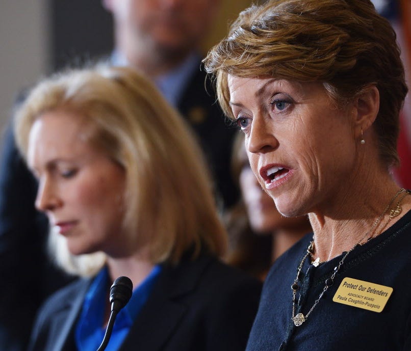 Retired Navy helicopter pilot Lieutenant Paula Coughlin (R), a victim of military sexual assault, speaks as Senator Kirsten Gillibrand (L), D-NY, looks on during a press conference calling for the creation of an independent military justice system to