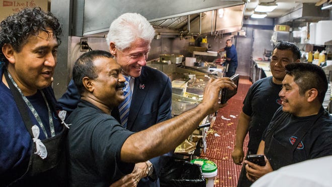 Former President Bill Clinton takes a photo with members of the kitchen staff at the Hollywood Grill in Wilmington on Sunday afternoon.