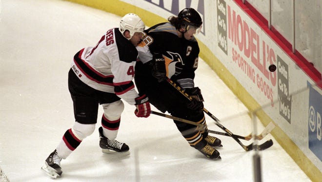 Jaromir Jagr of the Pittsburgh Penguins moves for the puck with Scott Stevens of the New Jersey Devils during a 1999 game at the then-Continental Airlines Arena.
