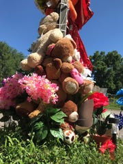 A memorial of teddy bears and flowers near the intersection