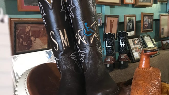 A pair of custom-made boots sits on a saddle at J.L. Mercer Boots in San Angelo. The boots were presented to local veteran Scott Morris, a participant in the Sonrisas Trails Therapeutic Riding Program.