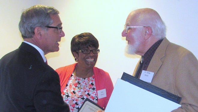 Chemung County Executive Tom Santulli, left, congratulates Dr. Mike Wald on Monday for his recognition as county Senior Citizen of the Year. Looking on is award nominee Ruby Givens.