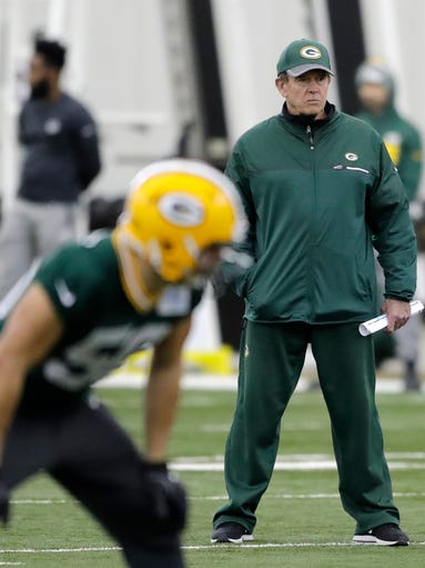 Packers defensive coordinator Dom Capers watches during