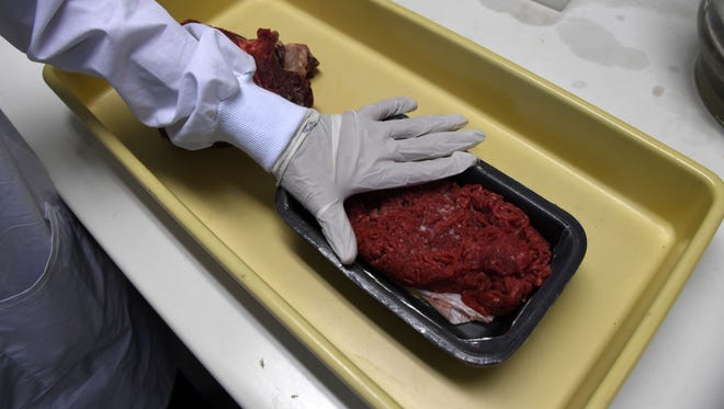 Experts get ready to test beef seized in different markets March 20 in Rio de Janeiro.