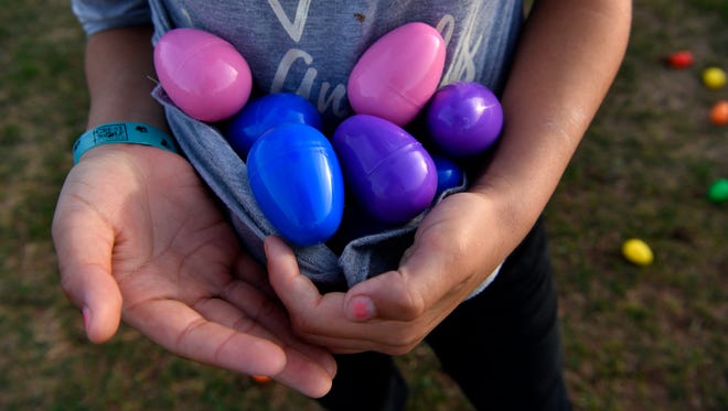 Semaria Rangel, 10, made an impromptu pouch with her shirt to carry eggs after she had filled her bucket Saturday in the city's annual Evening Easter Egg Hunt, sponsored by the Parks and Recreation Department. The hunt was held at the Lee Sports Complex.