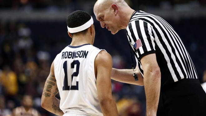 Mar 7, 2016; Albany, NY, USA; A referee speaks to Monmouth Hawks guard Justin Robinson (12) during the first half of the MAAC conference tournament finals against the Monmouth Hawks at Times Union Center.