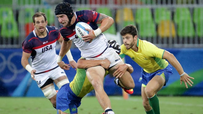 United States forward Garrett Bender breaks a tackle during a rugby sevens match against Brazil at Deodoro Stadium in the Rio Summer Olympic Games.