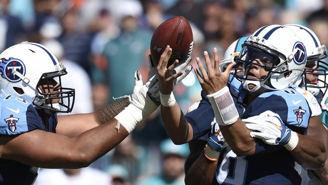 Titans quarterback Marcus Mariota bobbles the ball before fumbling in the second quarter against the Dolphins.