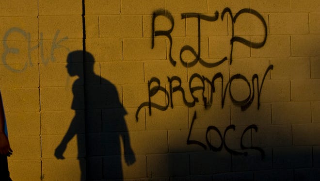 Gang signs adorn a block wall on Bowker Street in south Phoenix in 2008.