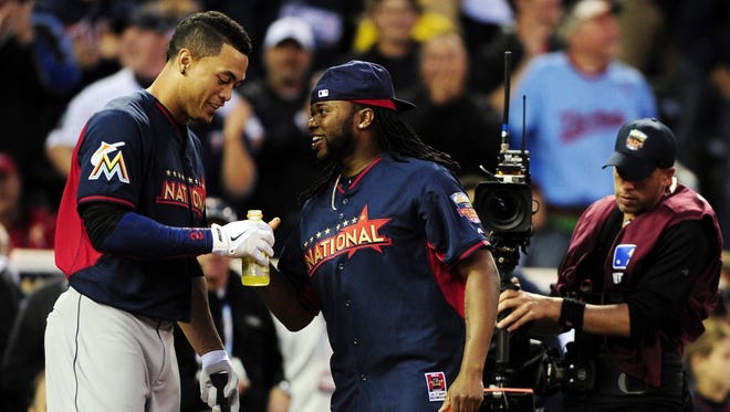 The Marlins' Giancarlo Stanton and the Reds' Johnny Cueto joke around during last year's Home Run Derby in Minneapolis. Note: The injured Stanton has been replaced in the All-Star Game starting lineup by the Pirates' Andrew McCutchen.