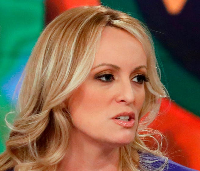 Adult film actress Stormy Daniels, left, with her attorney Michael Avenatti appear on the daytime talk show 'The View,' Tuesday, in New York. Daniels released a composite sketch of the man she says threatened her in a Las Vegas parking lot to stay qu