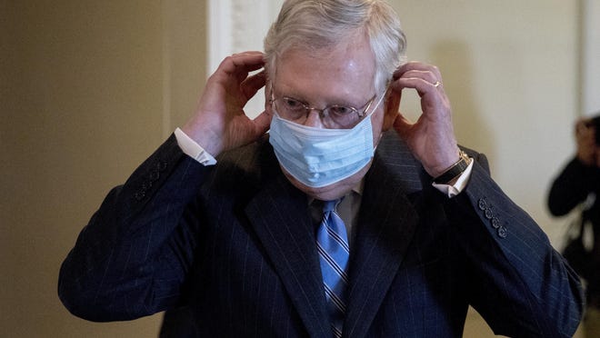 Senate Majority Leader Mitch McConnell of Ky., leaves a news conference announcing a Republican police reform bill on Capitol Hill on June 17, 2020, in Washington. While President Donald Trump avoids wearing a mask in public, McConnell said facial coverings are "really important" until a vaccine is found.