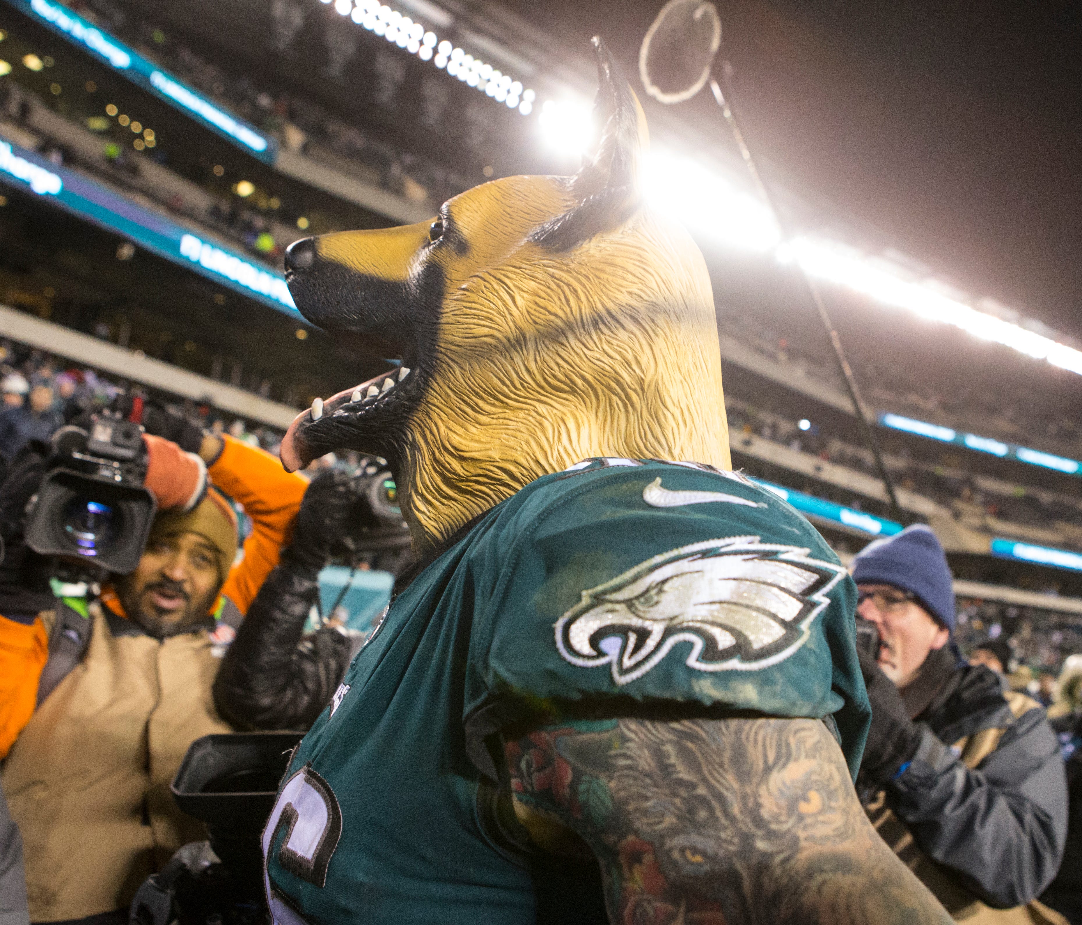 Eagles' Chris Long, 56, wears a dog mask into the tunnel after defeating the Atlanta Falcons 15-10.