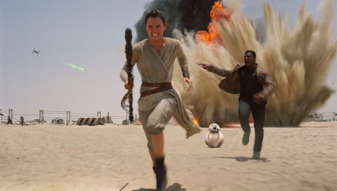 Daisey Ridley (Rey), left, and John Boyega (Finn), in a scene from "Star Wars: The Force Awakens."