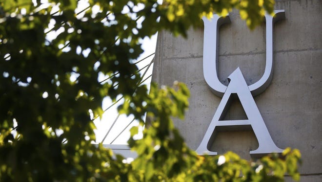 The University of Akron logo seen through the trees on Buchtel Avenue.